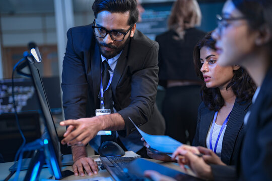 A team of financial analysts works through the night in a fast-paced firm, processing market data, reviewing performance reports, and executing trades to manage investment portfolios. - Powered by Adobe