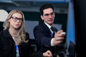 A diverse and dedicated team of professionals works diligently in a bustling, modern tech office at night, collaborating and focusing on their tasks to meet a critical project deadline.