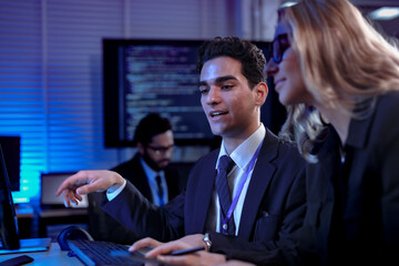 Professionals in a future workshop learn to collaborate with an AI, taking notes as the AI explains its complex code, a process known as augmented cognition for rapid upskilling.