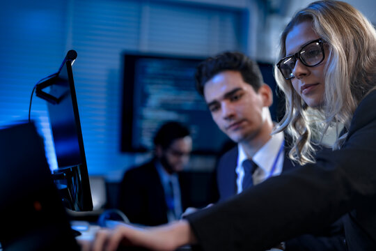 A diverse team of young professionals engages in intensive training, diligently taking notes from a presentation in a modern classroom, focused on their career growth and development. - Powered by Adobe