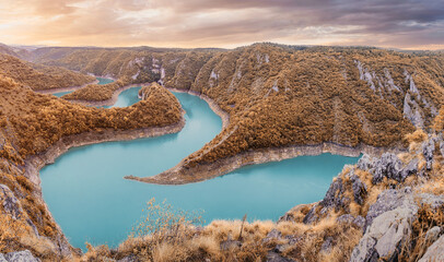 Uvac River forming breathtaking turquoise meanders, winding through a deep canyon with forested slopes in Serbia during autumn