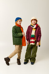Stylish childhood fashion showcased by two kids in vibrant winter outfits