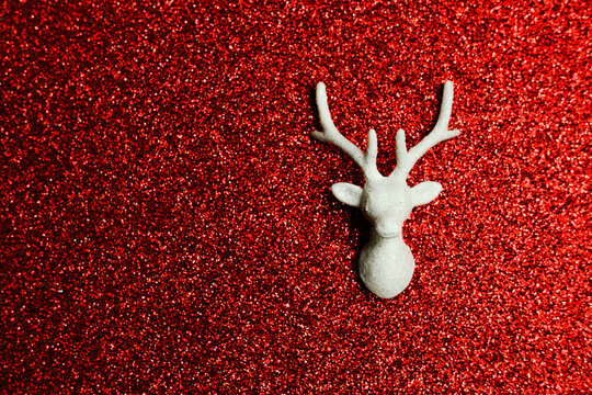 Christmas Reindeer Head on Shiny Red Background. Place for text.