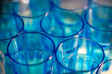 Blue transparent glasses stacked together creating an abstract pattern