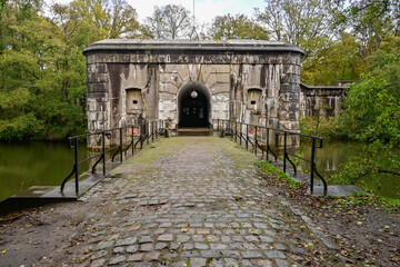 Exploring the historic war fort of Oelegem in Belgium surrounded by lush greenery and a calm waterway