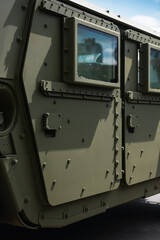 Doors of armored military vehicle. Side part of armored personnel carrier - left side with two doors made of thick steel with lots of bolts or rivets.