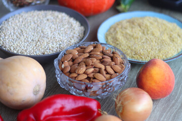 Assortment of various healthy fruits, vegetables, grains and legumes. Selective focus, wooden background.
