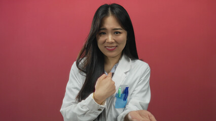 Scientist woman making a gesture for please over a red background, wearing a uniform, highlighting...