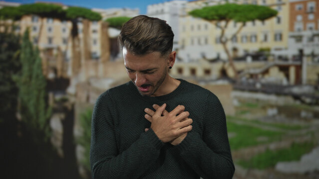 Hispanic man clutching chest in roman ruins with weathered marble columns and sunlit stone pathways reflecting ancient history; pain. - Powered by Adobe