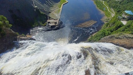 Majestic waterfall plunges into river