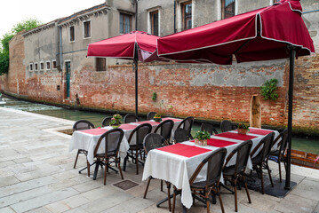 Traditional Italian outdoor restaurant with umbrellas