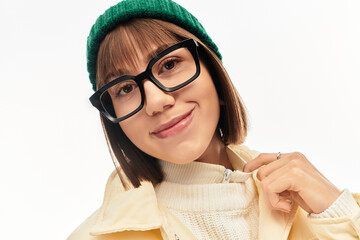 Stylish young woman exudes confidence in trendy attire with a green beanie