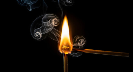 Striking a Match Bright Flame and Swirling Smoke Isolated on Black Background