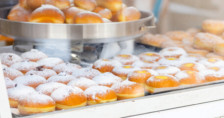 Bomboloni pastries selling at a Christmas market stall in Empoli, Tuscany