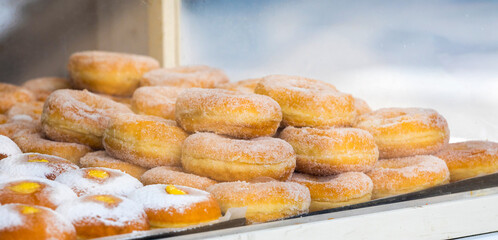 Sugared donuts and cream pastries selling at market stall
