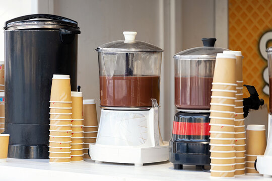 Hot chocolate dispensers with paper cups at Christmas market