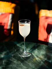 Refreshing cocktail served in a stemmed glass indoors