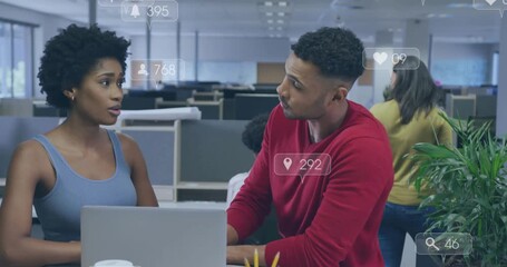 Woman speaking, gesturing at laptop while man pointing, reviewing marketing metrics overlaying desk - Powered by Adobe