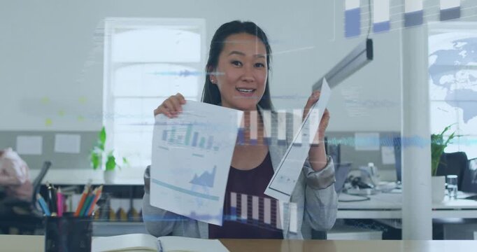 Office manager holding two reports and comparing charts while projecting business data onto glass