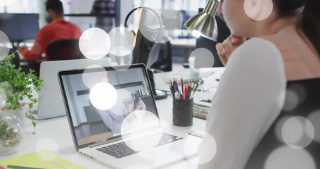 Woman resting chin watching host showing chart bokeh obscuring view then fading clear for training - Powered by Adobe