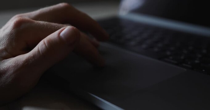 Male hand using a touchpad on a laptop. Video contains original audio.