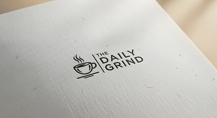 Stylish coffee cup brand identity on textured white paper showcasing minimalist logo design
