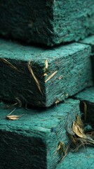 Stacked green blocks composed of natural fibers, highlighting unique textures and organic materials, ideal for eco-friendly design concepts and sustainable product development