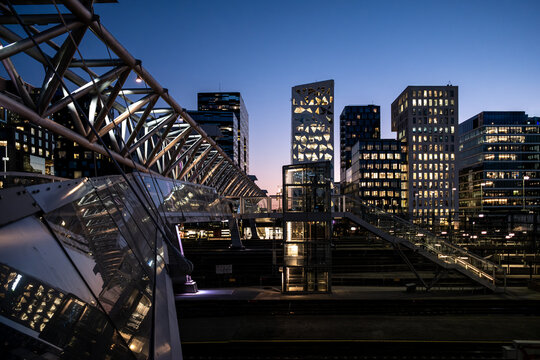 Architecture cityscape of Barcode Oslo blending night skyline with structure and bridge elements where lights define an urban detail in the contemporary setting.