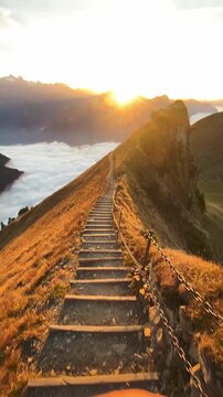 Sunset on the ridge hike from Stoos with a stepped path in the foreground and a breathtaking sea of fog in beautiful autumn time