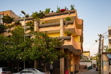 Obraz premium Multi-level house with flowers on balconies Durres, Albania 11.11.2025