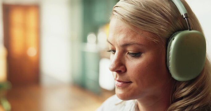 Headphones, relax and woman in home with music, radio or album with dance, calm or peace. Audio tech, break and female person listening to playlist or song on weekend in living room at apartment.