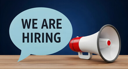 We are hiring announcement with a megaphone on a wooden table against a dark blue background perfect for job postings recruitment campaigns and employment opportunities promotion