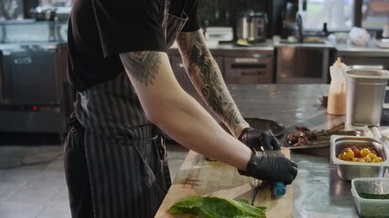 Side view shot of unrecognizable male chef gently pressing down on wrapped piece of meat shaping and forming it before serving to customers in restaurant, copy space