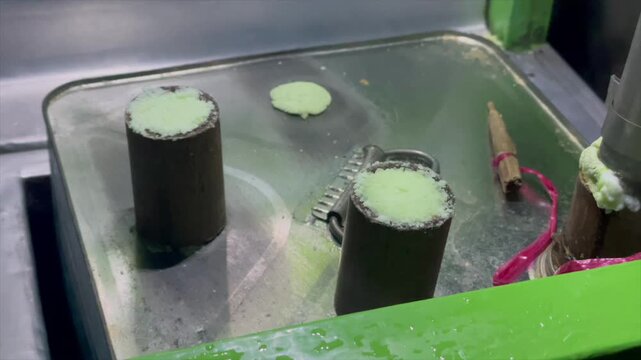 Video cooking or serving kue putu (traditional steamed rice cake).