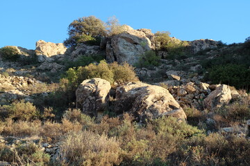 Beautiful mountain landscapes; rocky mountains; valleys; desert flora; blue skies;
