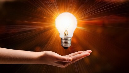 hand holding glowing lightbulb