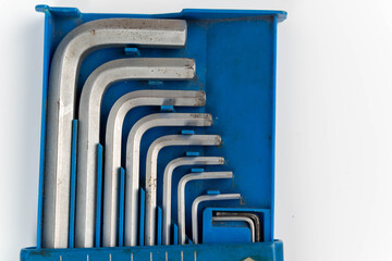 Set of metal hex keys arranged neatly in a blue plastic holder, showcasing various sizes and shapes, ideal for mechanical and DIY projects with tools