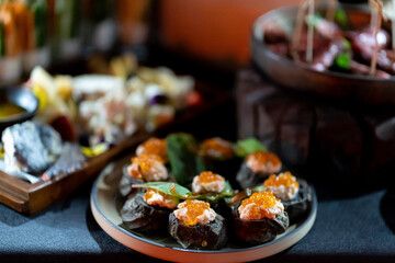 Pumpernickel bread sandwich snack with cured smoked salmon and fresh avocado served as close-up on a wooden cutting board
