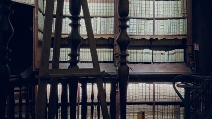 Fototapeta premium Historic book stacks and wooden balusters in shallow defocus, interior; background backdrop backplate template.