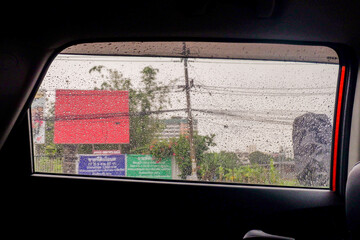 View from the inside of a working car,Car traffic jam,illuminated road during heavy rain and thunderstorms,highways in big cities,Rain drops on the car glass.