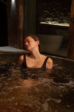 Relaxing evening in a cozy hot tub by a wooden cabin