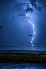 Tropical Lightning Storm in the Ocean over a Fishing Pier