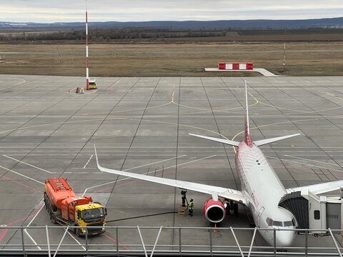 Samara Kurumoch Airport, Russia, November 9, 2025: A Russia Airlines aircraft with a boarding bridge from the airport terminal to it