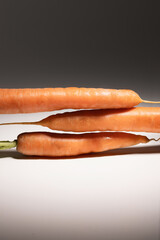 Peeled carrot with sprout standing upright on white background, fresh and healthy, perfect for food, nutrition, organic, and vegetable imagery