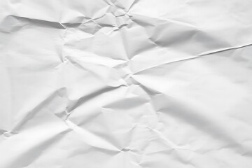 Close up of textured white crumpled paper with shadows and highlights