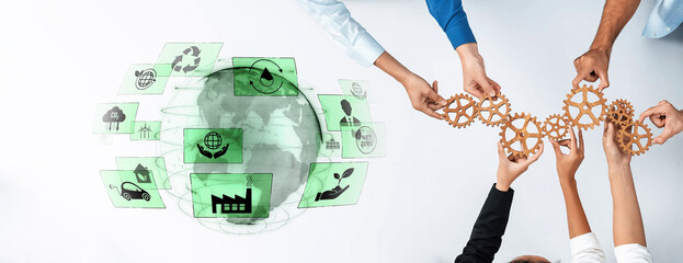 Hands work together to connect gears, symbolizing collaboration and innovation in sustainability, against a backdrop of a global environment concept. Trope