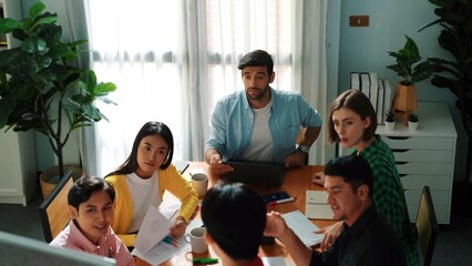 Top view of project manager looking at data analysis from business team at meeting. Skilled people brainstorming and discussing while looking at financial graph or stock market report. Convocation.