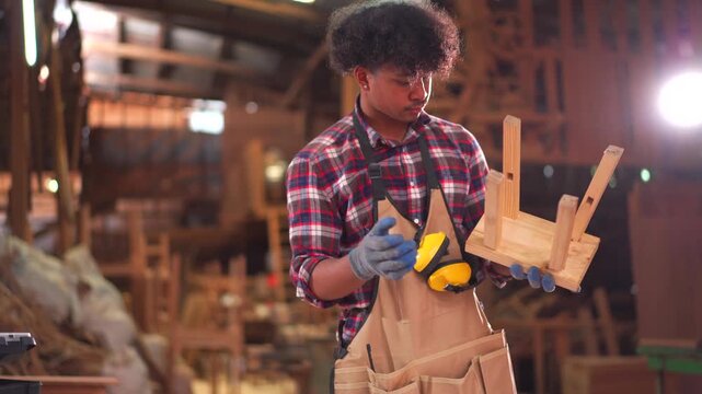Carpenter drawing and checking wooden project plans in a workshop. - Powered by Adobe