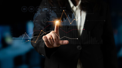 A business professional uses advanced technology to interact with digital financial data. The image showcases graphs and charts for insightful analysis in a modern setting. Scalp