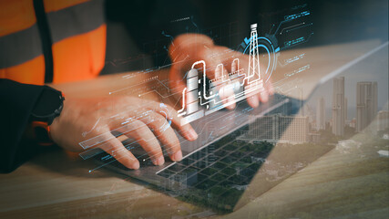 Engineer using laptop with holographic oil refinery plant overlay. Concept of smart factory automation technology, future energy innovation, and industrial digital transformation.